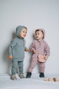 Baby fashion. Unisex gender neutral clothes for babies. Two Cute baby girls or boys in cotton set