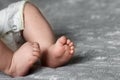 Baby feet close up on bedspread Royalty Free Stock Photo