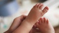 baby feet close up. dad holds a baby daughter legs in hands close-up indoors. happy family kid dream concept. feet toes Royalty Free Stock Photo