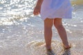 Baby feet close-up on the sand of the sea beach. Sea water washes the feet. Happy childhood. Rest at the sea. Summer Royalty Free Stock Photo