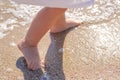 Baby feet close-up on the sand of the sea beach. Sea water washes the feet. Happy childhood. Rest at the sea. Summer Royalty Free Stock Photo