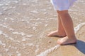 Baby feet close-up on the sand of the sea beach. Sea water washes the feet. Happy childhood. Rest at the sea. Summer Royalty Free Stock Photo