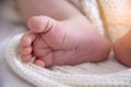 Baby Feet Closeup. Parent Care of Newborn Baby.