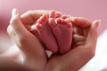 Baby feet cupped into mothers hands Royalty Free Stock Photo