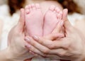 Baby feet cupped into mothers hands Royalty Free Stock Photo