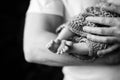 Baby feet in father hands. Black-and-white photo. Baby`s feet in black and white