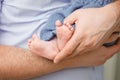 Baby feet in father hands. Tiny Newborn Baby's feet Royalty Free Stock Photo