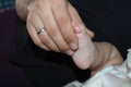 Baby feet in father hands. Tiny newborn baby& x27;s feet on male hands closeup. Dad and his child. Happy Family concept Royalty Free Stock Photo