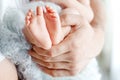 Baby feet in father hands. Tiny newborn baby`s feet on male hands closeup. Dad and his child. Happy Family concept. Beautiful Royalty Free Stock Photo