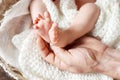 Baby feet in father hands. Tiny newborn baby`s feet on male hands closeup. Dad and his child. Happy Family concept. Beautiful Royalty Free Stock Photo