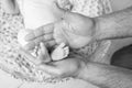 Baby feet in father hands. Tiny Newborn Baby`s feet on male hands closeup. Dad and his child. Happy Family concept. Beautiful Royalty Free Stock Photo