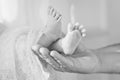 Baby feet in father hands. Tiny Newborn Baby`s feet on male shaped hands closeup. Dad and his Child. Happy Family concept Royalty Free Stock Photo