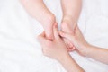 Baby feet on a female hand close up on white background. Mom and her child. Copy space Royalty Free Stock Photo