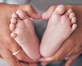 Baby, feet and hands of mother closeup with newborn for love, care or family bond in their home. Zoom, mom and foot of Royalty Free Stock Photo