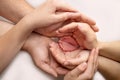 Baby feet in the hands of mother, father, older brother or sister, family. Royalty Free Stock Photo