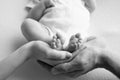 Baby feet in the hands of mother, father, older brother or sister, family. Royalty Free Stock Photo