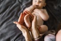 Baby feet in the hands of the mother. Tiny legs of a newborn baby on female hands close-up Royalty Free Stock Photo