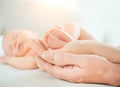 Baby feet in mother and father hands. Tiny Newborn Baby`s feet on hands closeup. Happy Family concept. Parents Royalty Free Stock Photo