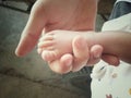 baby feet in mother hands close up with soft focus and vintage tone Royalty Free Stock Photo