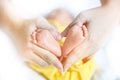 Baby feet in mother hands - hearth shape, Baby feet in mother hands. Mom and her Child. Happy Family concept. Beautiful conceptual Royalty Free Stock Photo