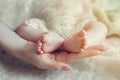 Baby feet in mother hands. Mom and her Child. Happy Family concept. Beautiful conceptual image of Maternity Royalty Free Stock Photo