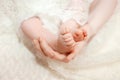 Baby feet in mother hands. Mom and her child. Happy family concept. Beautiful conceptual image of Maternity Royalty Free Stock Photo