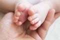 Father holds the leg of a newborn baby boy Royalty Free Stock Photo