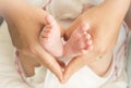 Baby feet in mother hands - hearth shape Royalty Free Stock Photo