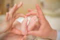 Baby feet in mother hands. Mom and her Child. Happy Family concept. Beautiful conceptual image of Maternity. Life. Royalty Free Stock Photo