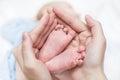 Baby feet in mother hands. Mom and her Child. Happy Family concept. Beautiful conceptual image of Maternity. Mother holds newborn Royalty Free Stock Photo