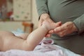 Baby feet in mother hands. Mom and her Child. Masseur massaging little baby`s foot. Happy Family concept. Royalty Free Stock Photo