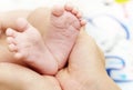 Baby Feet in Mother Hands. New Born Kid Foot Royalty Free Stock Photo