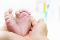 Baby Feet in Mother Hands. New Born Kid Foot Royalty Free Stock Photo