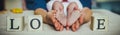 Baby feet in mother hands. Tiny Newborn Baby`s feet on female Heart Shaped hands closeup. Royalty Free Stock Photo