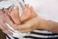 Baby feet on mother`s hand Royalty Free Stock Photo