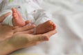 Baby feet on mothers hands Royalty Free Stock Photo