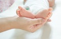 Baby feet are near the mother`s hand. Mother`s love Royalty Free Stock Photo