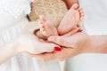 Baby feet in parents hands. Tiny Newborn Baby`s feet on parents shaped hands closeup. Parents and they Child. Happy Family concep Royalty Free Stock Photo