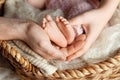 Baby feet in parents hands. Tiny Newborn Baby`s feet on ffamily hands closeup. Mom, dad and they child. Happy Family concept. Royalty Free Stock Photo