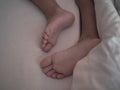 Baby feet sleeping on the baby`s bed