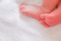 Baby feet sleeping in white bed