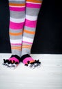 Baby feet in warm, long multicolored socks with toes Royalty Free Stock Photo