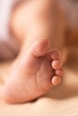 Baby feet on white coverlet. Toes. Feet how Horizontal photo. Royalty Free Stock Photo
