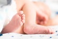 Baby feet on white coverlet. Toes. Horizontal photo.