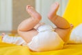 Baby feet on a yellow background. Selective focus