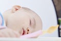 Baby fell asleep while feeding on a white background isolate