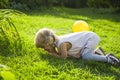 Baby fell and cries on a grass in a garden