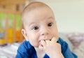 Baby with fingers in mouth Royalty Free Stock Photo