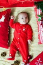 Baby first christmas. Beautiful little baby celebrates Christmas. New Year`s holidays. Baby with santa hat with gift.