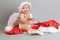 Baby first Christmas. Little child celebrates new Year holidays. Baby with santa hat with gift. Santa baby.